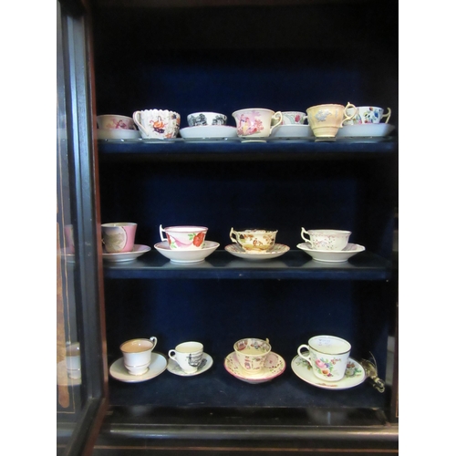 1069 - A selection of mostly early 19th Century and later cups and saucers, hand painted and transfer print... 