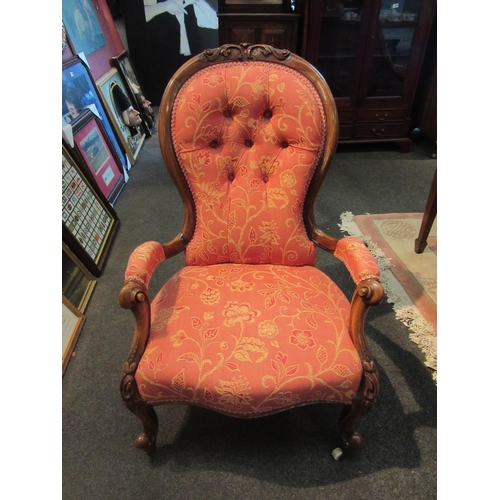 1097 - A Victorian walnut spoon-back armchair, buttoned foliate design upholstery, scroll arms and legs, on... 