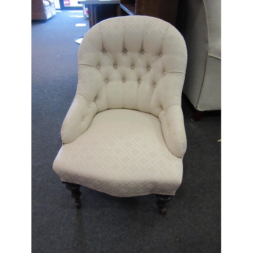 1098 - A late Victorian buttoned upholstered tub chair, diamond form white upholstery, raised on turned sup... 