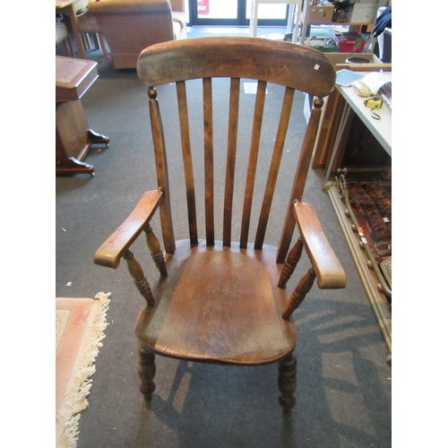 1099 - An oak lathe-back Windsor chair on turned supports with stretcher base