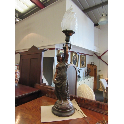 1102A - A spelter figural lamp, lady holding flame shade aloft