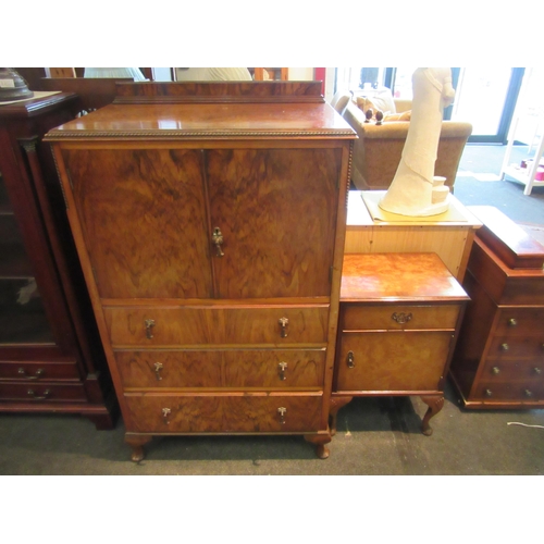 1103 - A 1930's walnut drinks cabinet, two doors over three long drawers, squashed bun feet, 132cm tall x 7... 