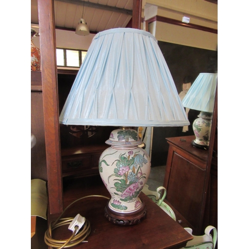 1110 - A pair of Oriental style table lamps with pale blue pleated shades