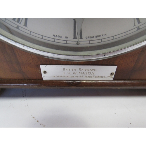 8028 - A walnut presentation Mantle clock by The Alexander Clarke Co. inscribed 