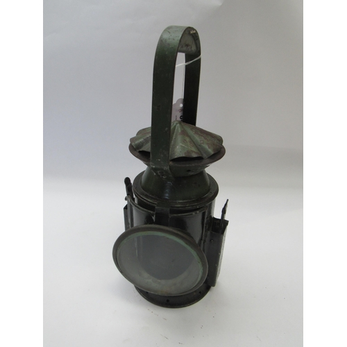 8034 - A three aspect army issue hand lamp, reservoir and burner interior, side plaque showing broad arrow ... 