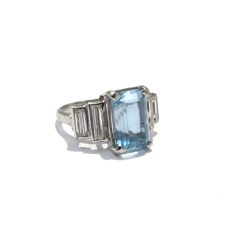 9418 - An 18ct white gold ring, central emerald cut aquamarine 4ct approx flanked by two graduated baguette... 