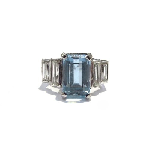 9418 - An 18ct white gold ring, central emerald cut aquamarine 4ct approx flanked by two graduated baguette... 