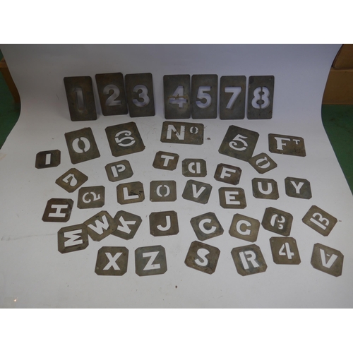 8307 - A box of metal letter stencils