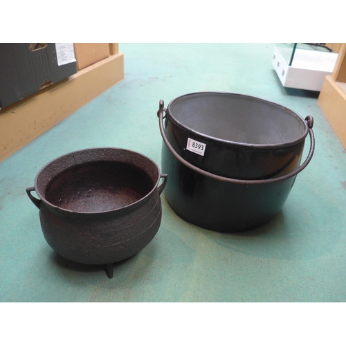 8393 - A cast iron three footed cauldron and enamel pot