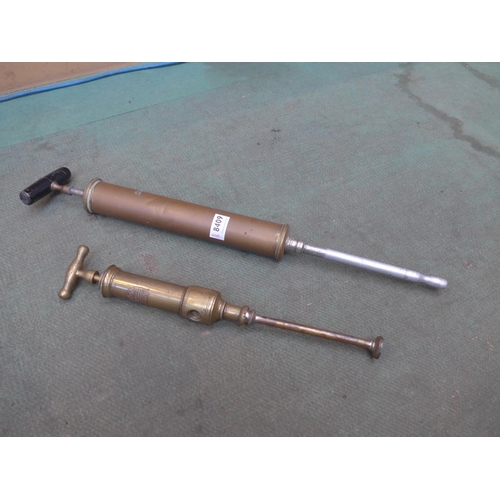 8409 - A Holborn clyster syringe and Arnold & Sons brass pump