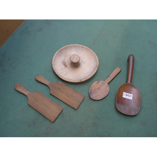 8425 - A pair of Scotch hands, butter press and two butter spoons