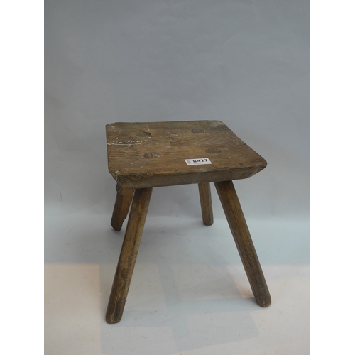 8427 - A wooden four legged milking stool