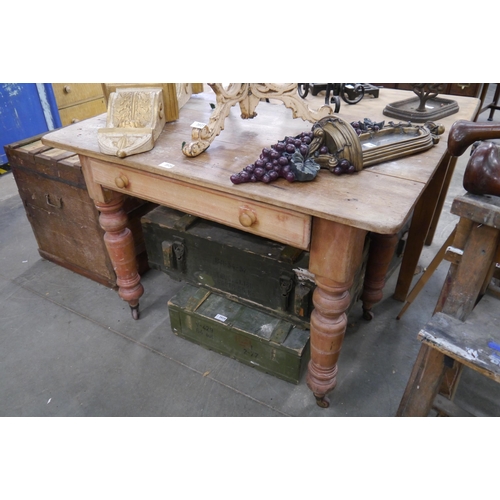 2028 - A Victorian pine single drawer kitchen table on castors 70cm x 110cm