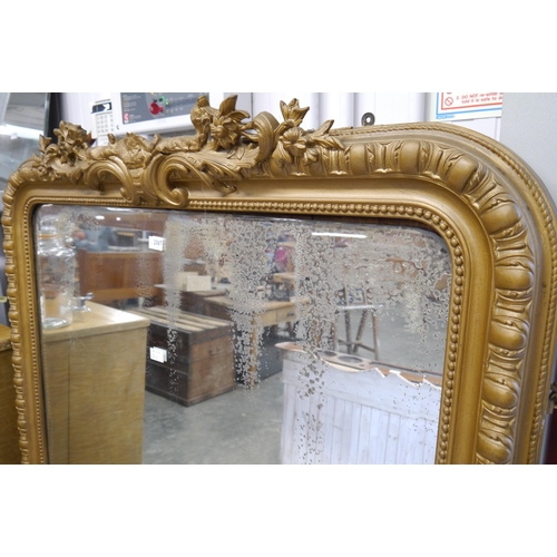 2087 - A Victorian gilt gesso overmantel wall mirror with scrolled foliate crest top and egg and dart frame... 