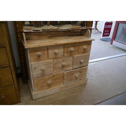 2089 - A country pine chest of nine drawers, turned handles, plinth base