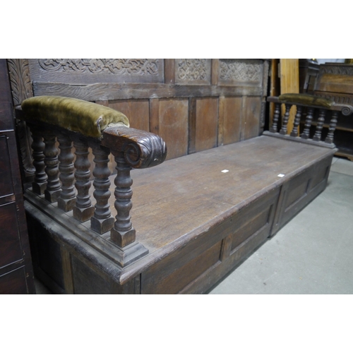 2096 - An 18th Century and later country oak settle of large proportions, carved composite high back