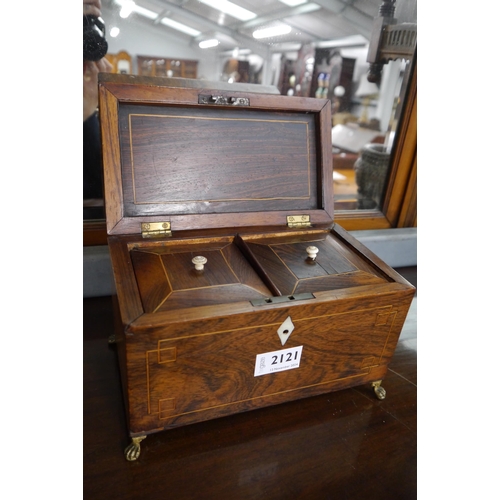 2121 - A Georgian Rosewood tea caddy with brass paw feet