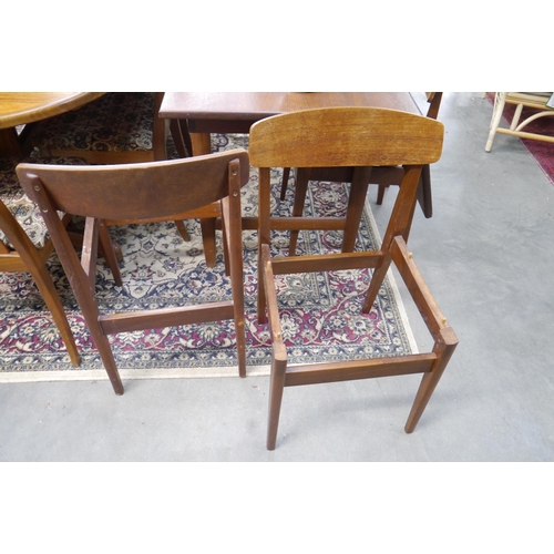 2429 - A set of four mid-century teak dining chairs, seats not included