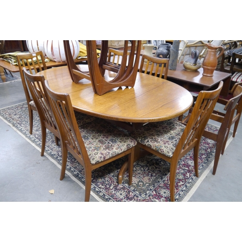 2433 - A 1970's G-Plan teak extending dining table of oval form, together with six matching slatted chairs ... 