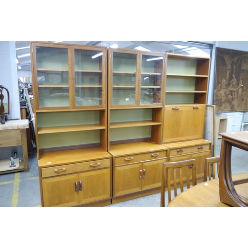 2434 - A 1970's G-Plan three section wall unit, the central bookcase with fall front cabinet, flanked by tw... 