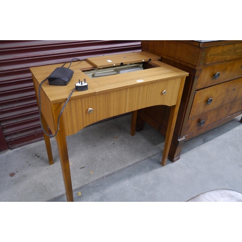 2438 - A 1970's Brother electric sewing machine within a table