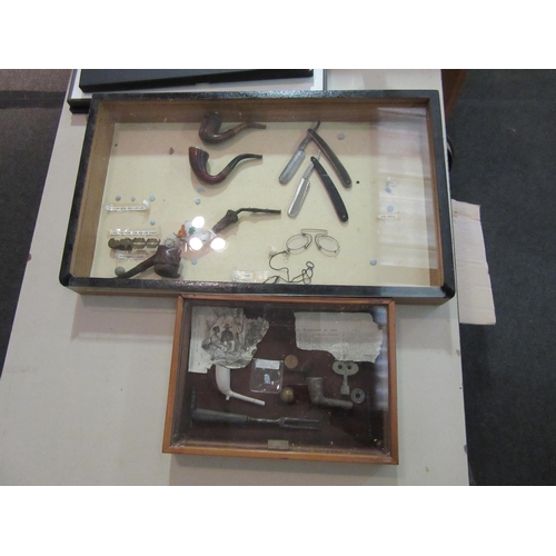 1528 - Two cased displays with pipes and razors etc.