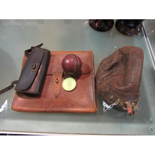 1554 - A vintage leather bicycle case, leather document wallet, leather football, cricket ball and judge ba... 