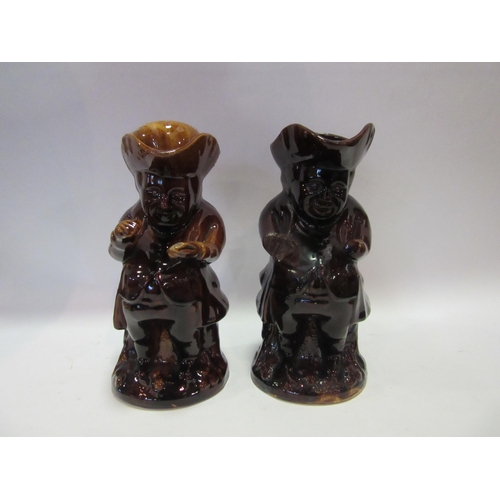 1557 - Two 19th Century brown/treacle glazed toby jugs, one lacking cover, both a/f