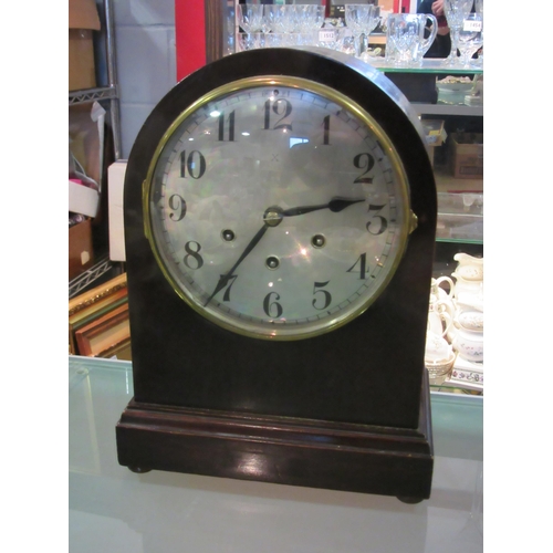 1559 - An eight day mantel clock with silvered dial and ball feet with key