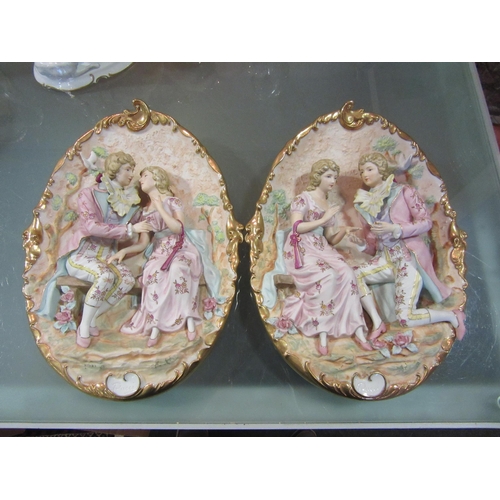 1562 - A pair of Capodimonte ceramic wall plaques depicting courting couples surrounded by Doves and flower... 