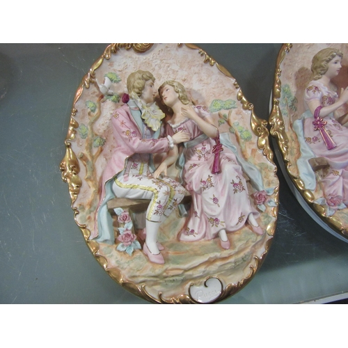 1562 - A pair of Capodimonte ceramic wall plaques depicting courting couples surrounded by Doves and flower... 