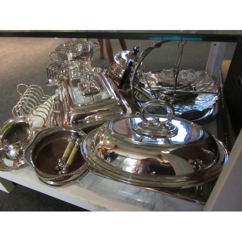 1590 - A good selection of silver plated items to include an asparagus serving tray entree dishes tea and c... 