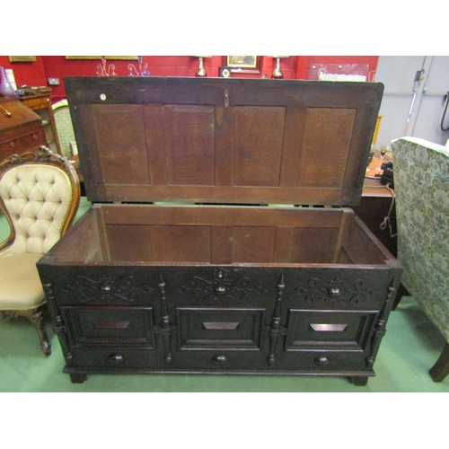 4210 - A circa 1800 pegged oak panelled coffer, the hinged four panel lid over a moulded and blind fret fro... 