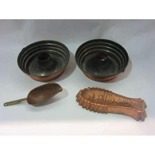 4264 - A pair of copper sponge rings, fish form mould and a brass handled copper scoop together with a roll... 