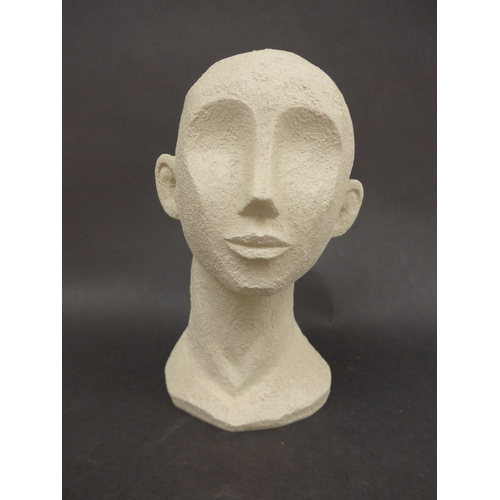 4040 - A resin stylised sculpture of a head, initialled PT to reverse, 24cm high