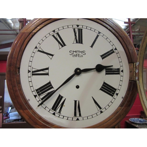 4106 - A Smiths Enfield wall hanging dial clock, Roman numeral face with pendulum, 39cm diameter