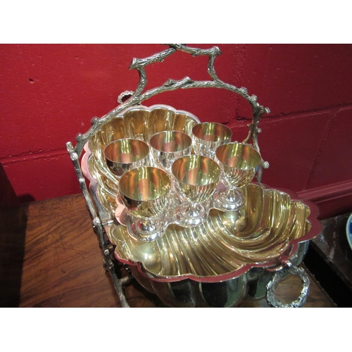 4131 - A Mappin & Webb silver plated and gilt lined scallop form egg cup holder housing six egg cups and wi... 