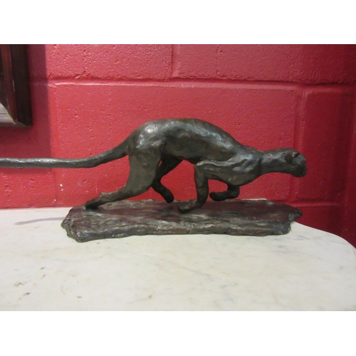 4164 - A cast bronze sculpture of a cheetah in chase. 47cm length. 15cm height