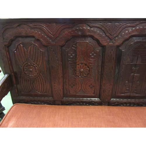 4180 - A 17th Century and later oak five panel back rest settle with carved decoration having a central her... 