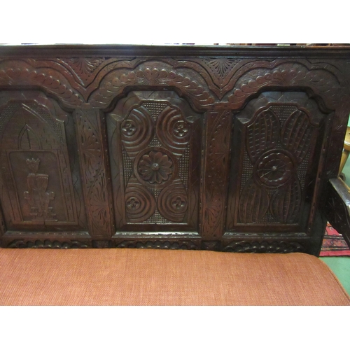 4180 - A 17th Century and later oak five panel back rest settle with carved decoration having a central her... 