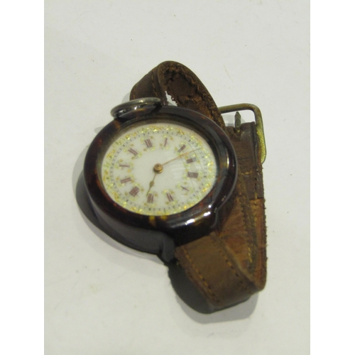 4401 - A fob watch in a faux tortoiseshell wristwatch holder with leather strap