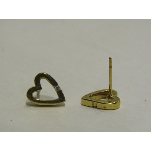 4413 - A pair of 9ct gold heart shaped stud earrings with single diamond, no backs, 1.5g