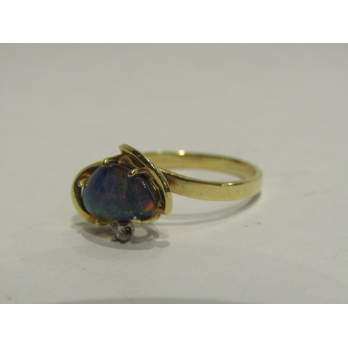 4438 - A gold ring set with an opal doublet and single diamond, 14k