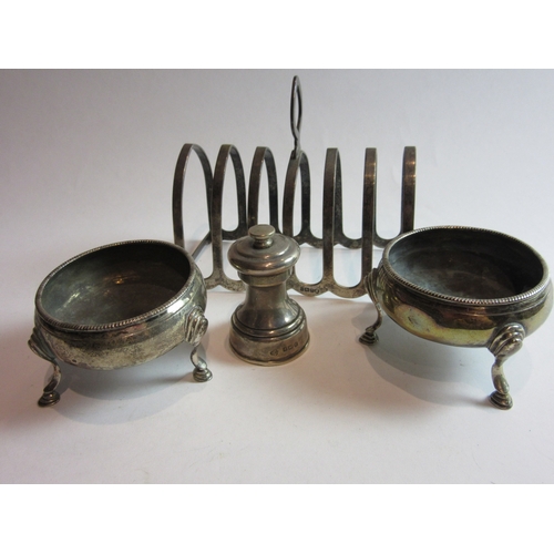 4380 - Four silver items comprising of two Georgian salts, a pepper grinder and toast rack