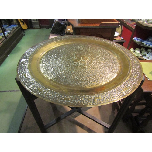 4229 - A brass top Benares table with central bird motive, 61cm diameter