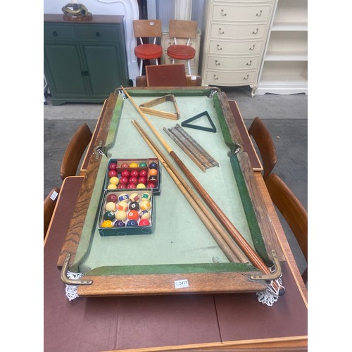 2427 - A miniature slate based child’s snooker table with balls , cues, scoring board, 133cm x 71