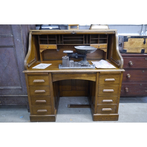 2071 - A 1930's oak tambour roll top twin pedestal desk