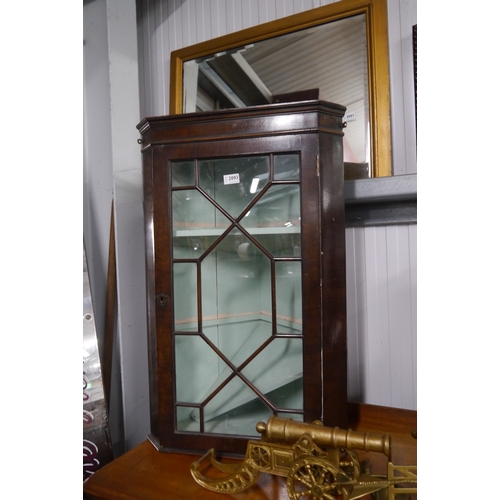 2093 - A glazed corner cabinet, painted interior