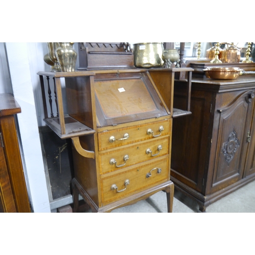 2108 - An Edwardian bureau, the fall front over three drawers, flanked by two bookshelf sections, raised on... 