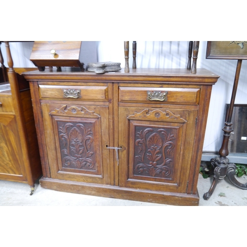 2128 - An Art Nouveau style mahogany sideboard, two drawers over two cupboard doors, plinth base, missing e... 